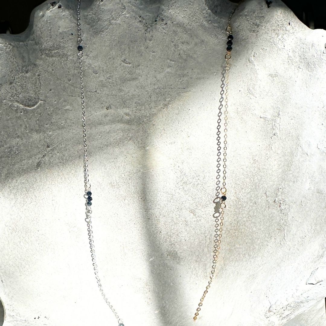 Sparkling sapphire gemstone chain with dainty flat cable links, customizable for elegant and practical jewelry designs.