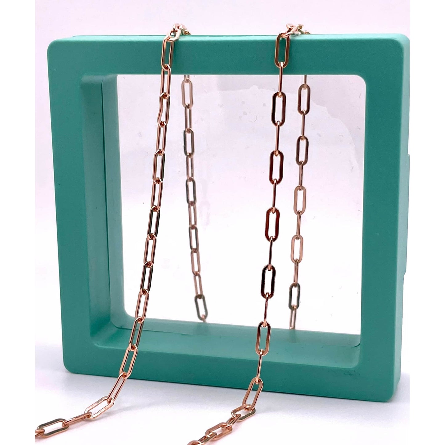 14k Rose Gold Filled Paperclip chain for permanent jewelry in a green hallow box.