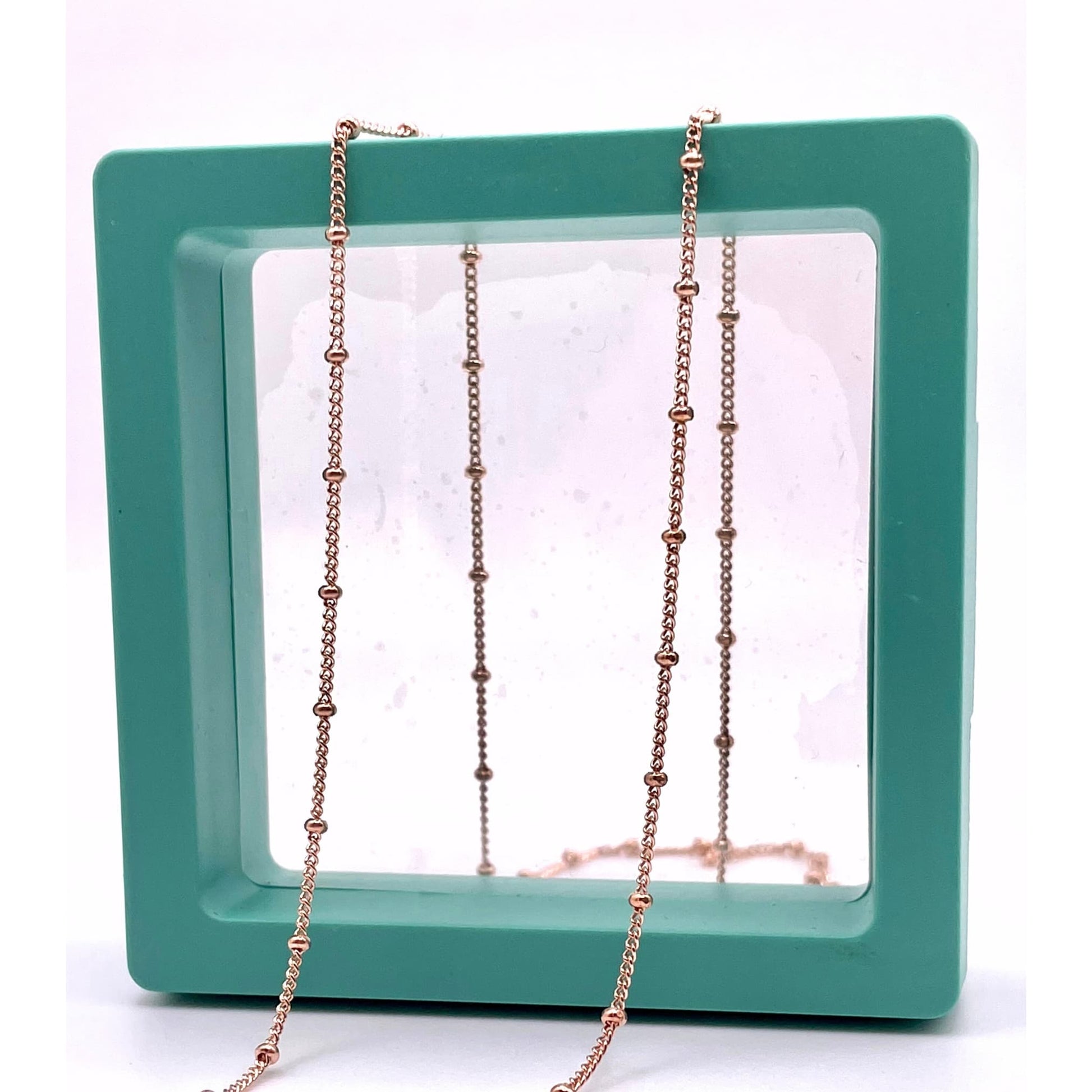 14k rose gold filled satellite chain for permanent jewelry in a green hallow box.