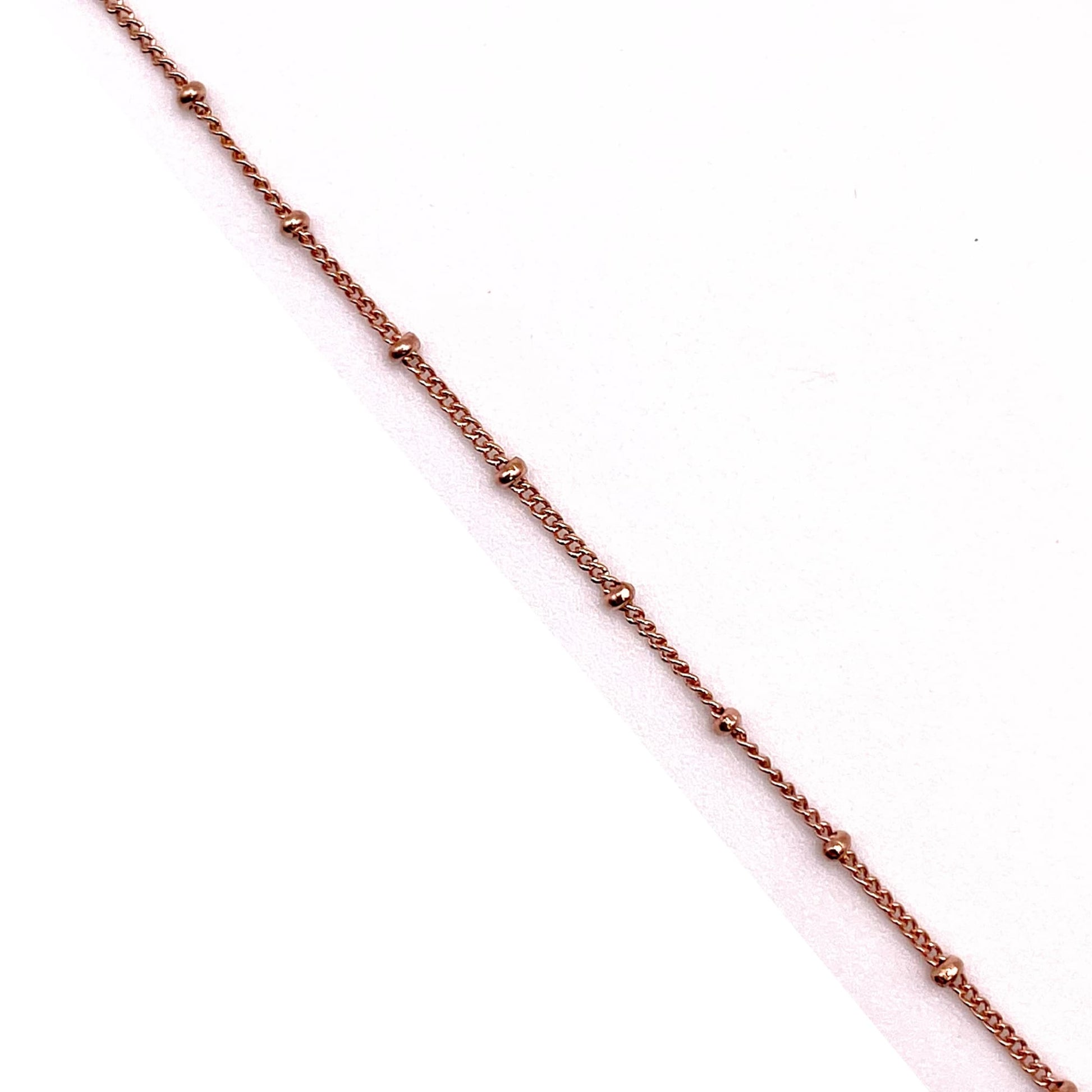 14k rose gold filled satellite chain in white background.