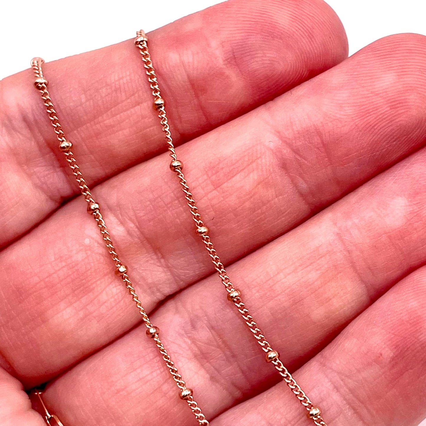 Actual photo of 14k rose gold filled satellite chain for permanent jewelry.