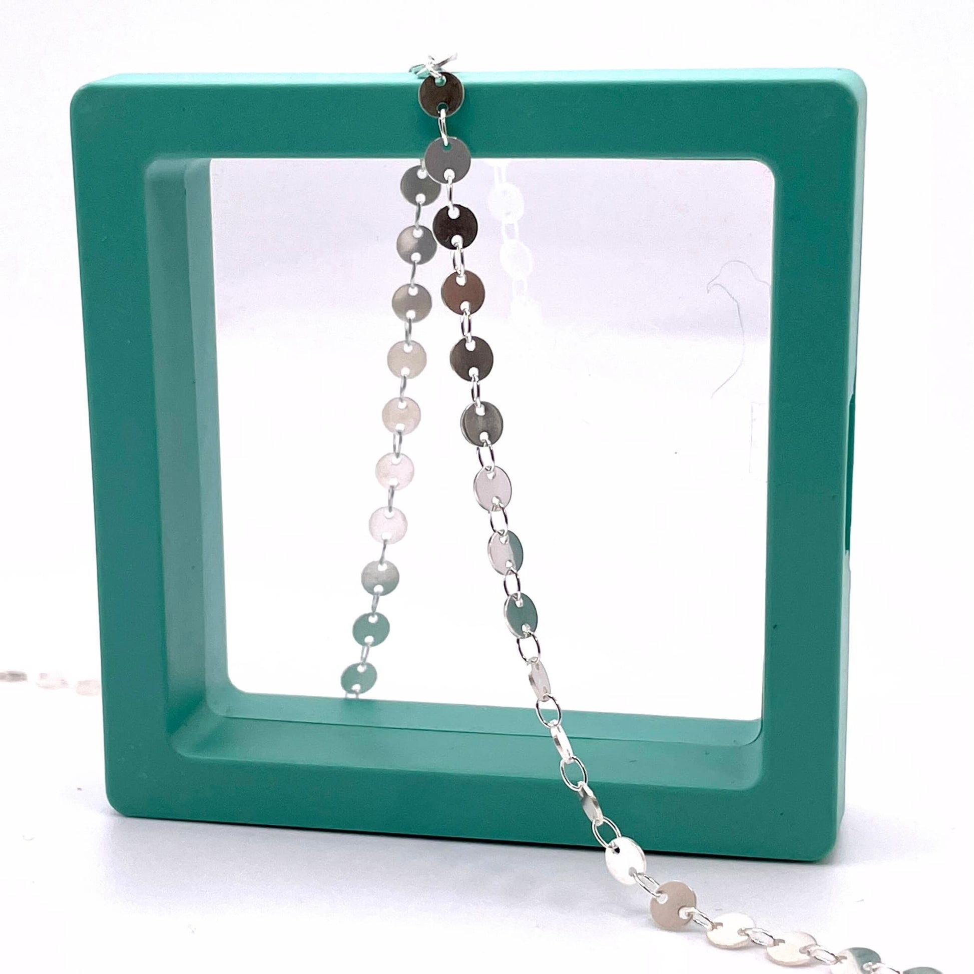 Sterling silver round sequin disk chain for permanent jewelry in a hallow box.
