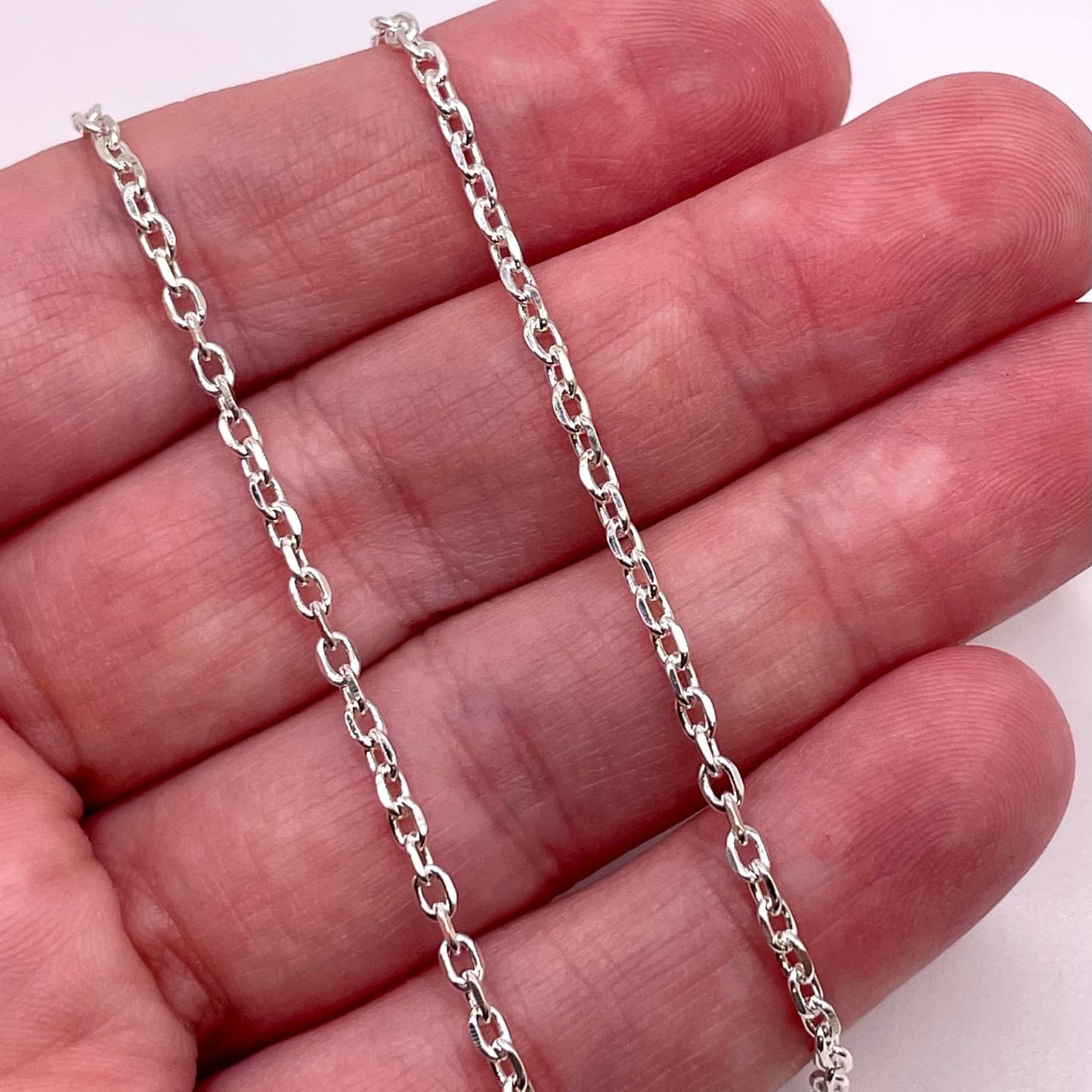 Actual photo of 925 Sterling Silver Diamond Cut Cable chain for permanent jewelry.