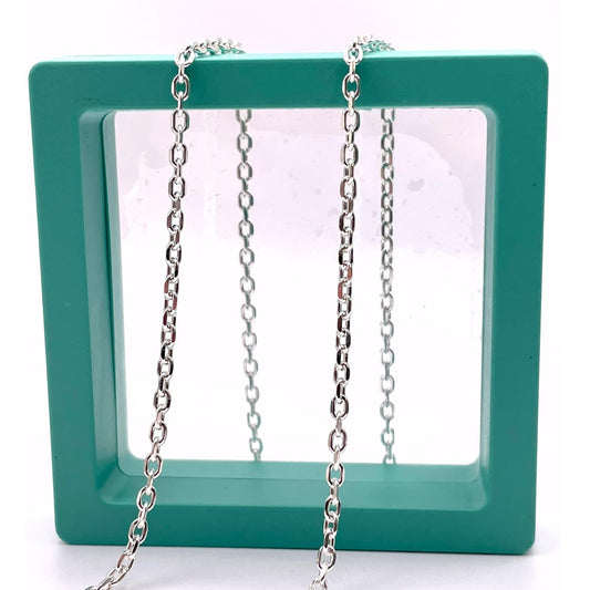 925 Sterling Silver Diamond Cut Cable chain for permanent jewelry in a green hallow box.