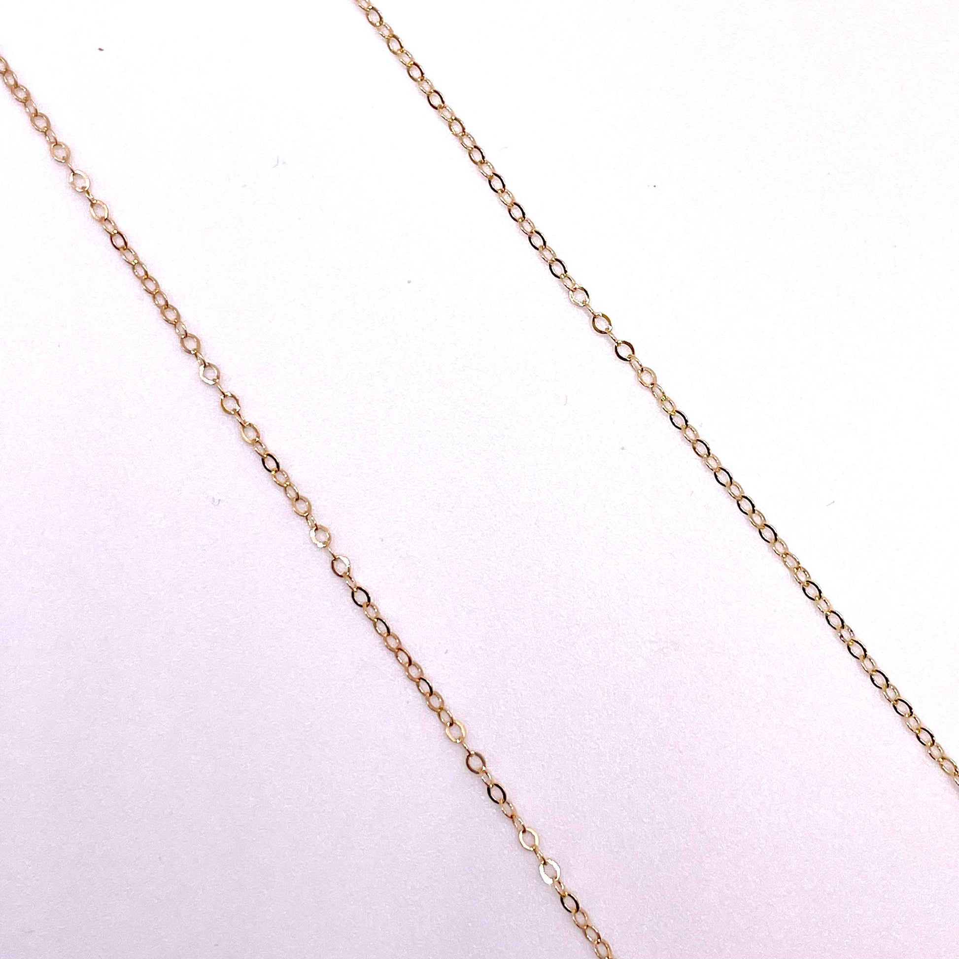 14k gold filled flat cable chain in white background.
